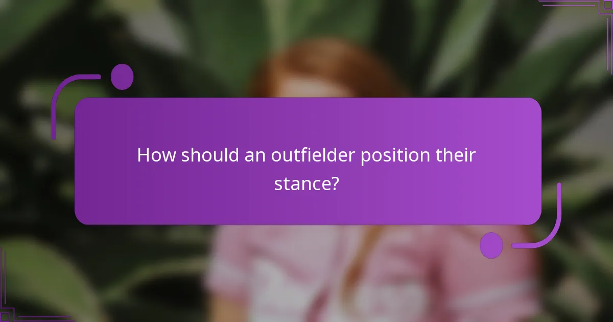 How should an outfielder position their stance?